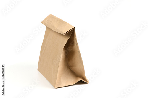 Close and full paper disposable bag of brown kraft paper isolated on white background.