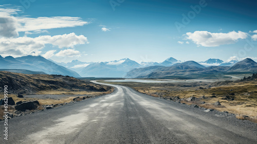 a long empty road and mountains in the background.