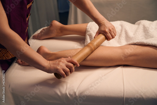 Fotografie Spa therapist giving calf massage to adult woman