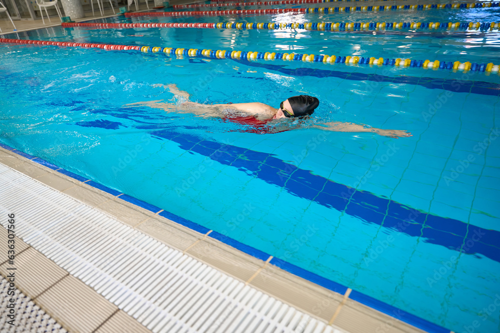Professional swimmer practicing freestyle stroke in swimming pool