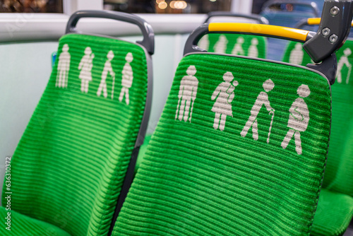 Wallpaper Mural Green seats on a bus with printed signs for elderly, mother with young child, pregnant women, disabled and obese people in Dublin Docklands, Dublin, Ireland Torontodigital.ca