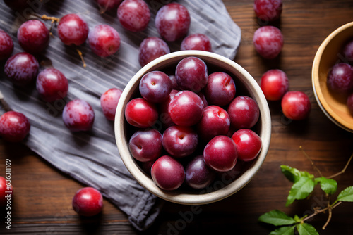 Plum fruits on a wooden kitchen counter. Naturally lit surroundings in boho style.