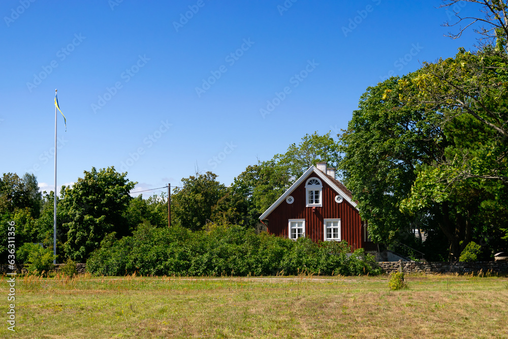 Red wooden house in the village Dörby, island of Öland, Sweden