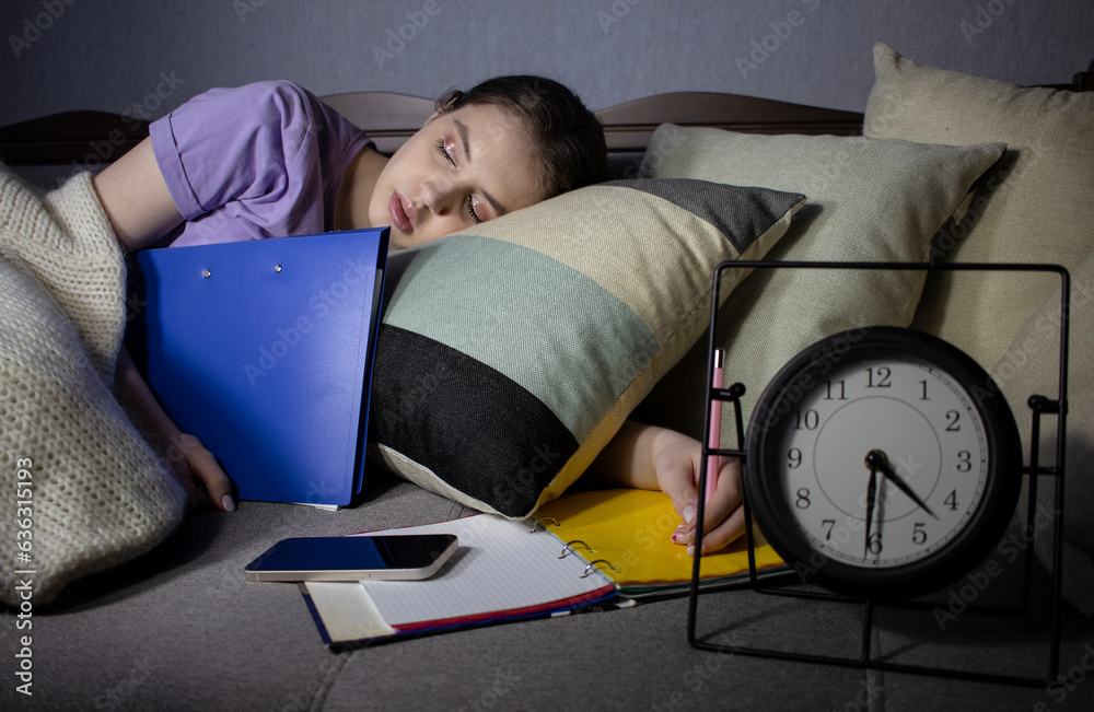 Fototapeta premium girl student fell asleep while doing homework