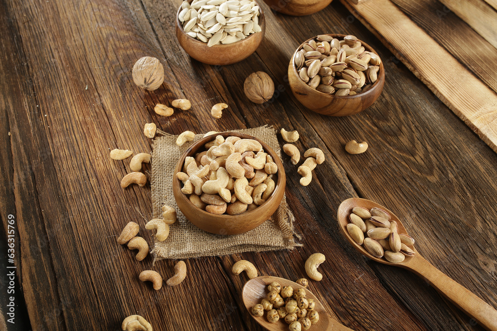 DRİED NUTS AND FRUİTS IN WOODEN BOWL ON BROWN FLOOR DRİED NUTS AND FRUİTS IN WOODEN BOWL ON BROWN FLOOR