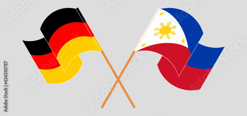 Crossed and waving flags of Germany and the Philippines