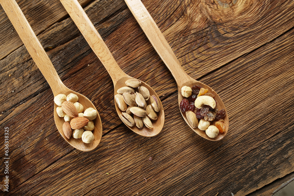 DRİED NUTS AND FRUİTS IN WOODEN BOWL ON BROWN FLOOR DRİED NUTS AND FRUİTS IN WOODEN BOWL ON BROWN FLOOR