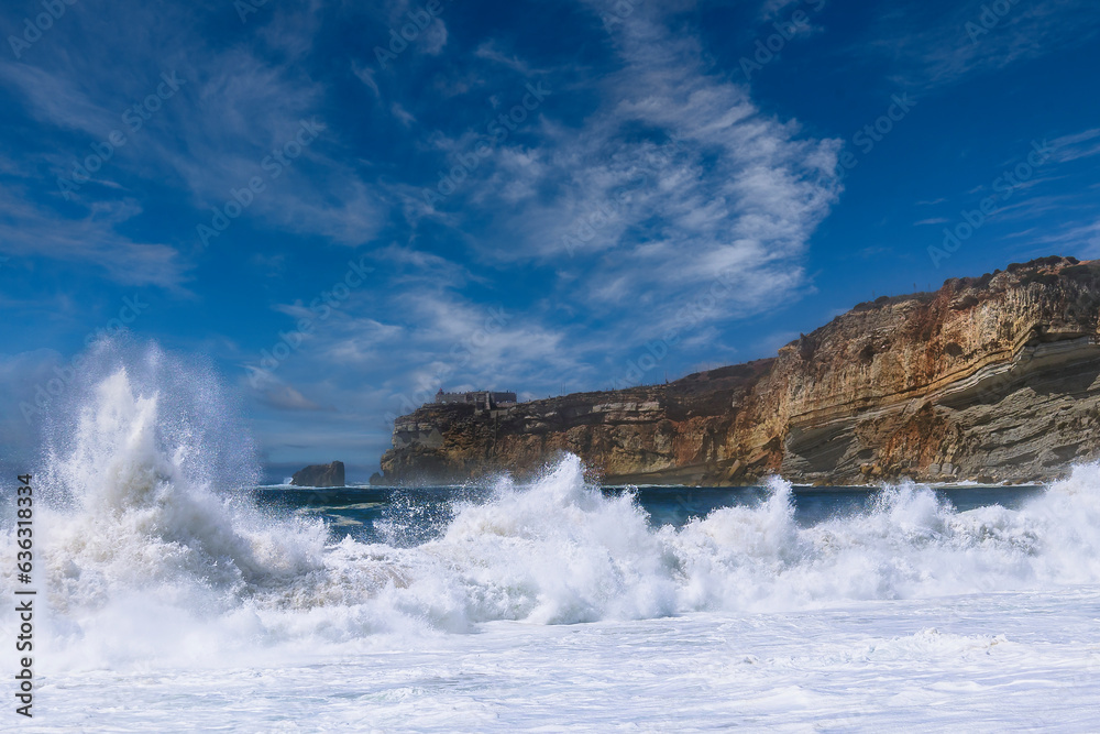 Obraz premium Nazare beach in Portugal, home of oonw of the biggest waves in the world. Nazare bi waves beach