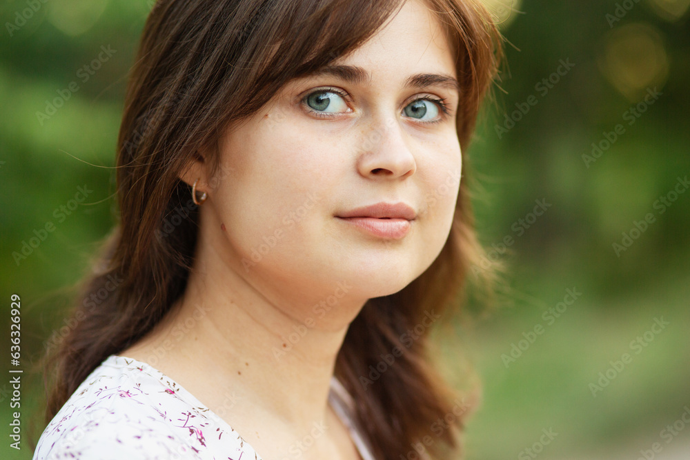 Portrait of a cute young romantic girl with brown hair in nature Portrait of a cute young romantic girl with brown hair in nature