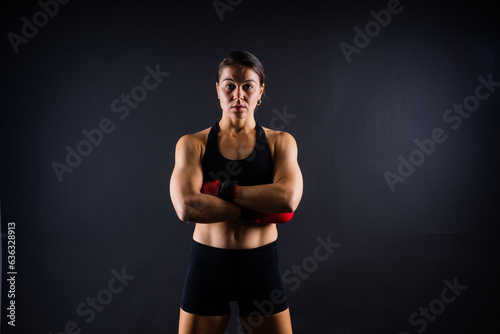 Fitness woman with the red boxing bandages and gloves, studio shot