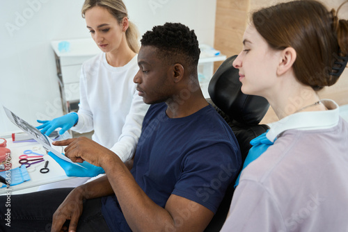 African American patient asking question about his teeth