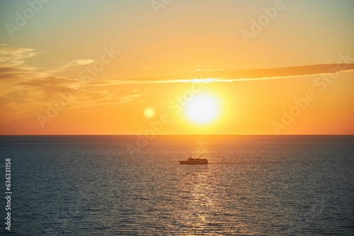 Beautiful landscape with sunset in the sea and a yacht © Fotoproff