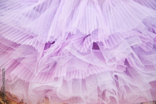 Pink tulle fabric. Flounces on a children's dress. Tailoring of fashionable clothes photo