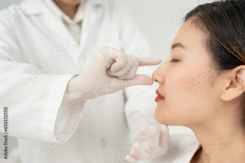 plastic surgery  beauty  Surgeon or beautician touching woman face  surgical procedure that involve altering shape of nose  doctor examines patient nose before rhinoplasty  medical assistance  health.