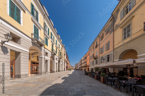 Cuneo, Piedmont, Italy - Cityscape on Via Roma main pedestrian cobblestone street with Ancient buildings decorated and with arcade in historic center