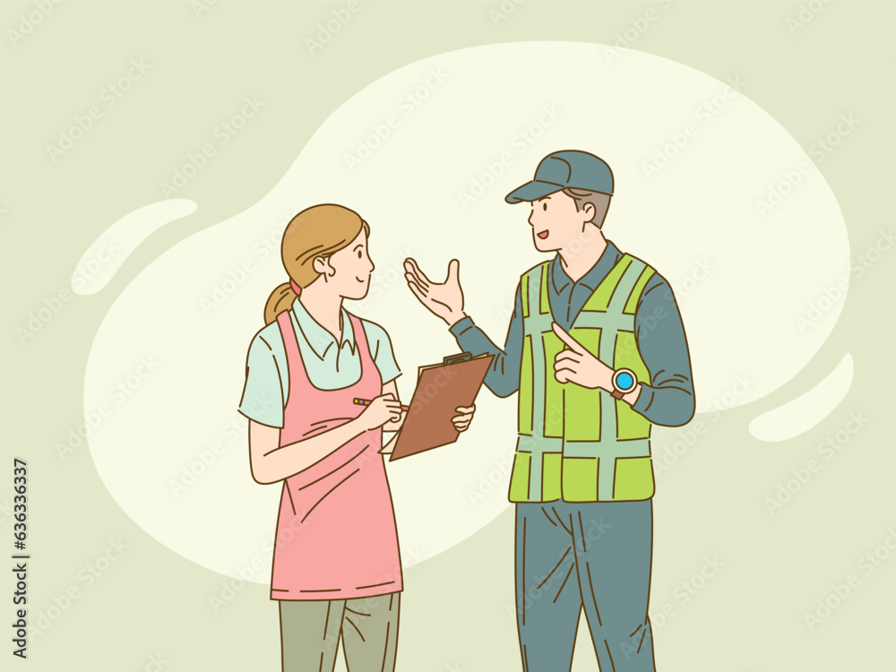 Woman in apron with clipboard speaks with mechanic Woman in apron with clipboard speaks with mechanic
