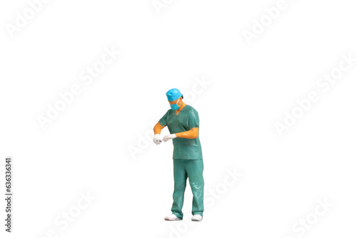 Miniature people Full length portrait of young doctor in scrubs Isolated on white background with clipping path