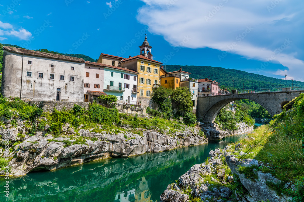 A view along the Soca river towards the bridge and the town of Kanal in Slovenia in summertime