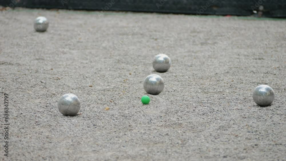 Petanque balls boules bowls on sand gravel court background in