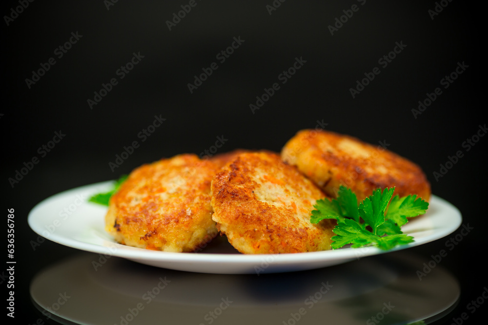 Cooked fried fish cutlets in a plate with herbs. Cooked fried fish cutlets in a plate with herbs.