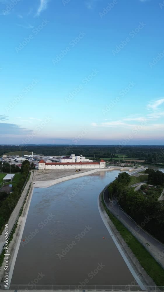 Vertical aerial shot in 4K of hydro power plant in Toeging am Inn with chanel and bridge Vertical aerial shot in 4K of hydro power plant in Toeging am Inn with chanel and bridge