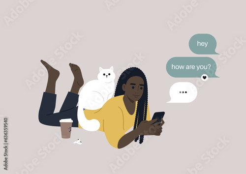 A youthful character reclining on their stomach, engrossed in checking their mobile phone's messenger app, meanwhile, a cat perches on their back, seeking attention