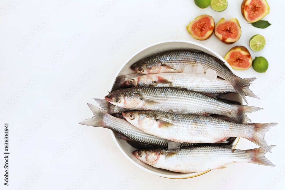 Mediterranean fish, Loban, Mullet, seafood, bowls on white background, top view, free space, place for text, background image, background for presentations Mediterranean fish, Loban, Mullet, seafood, bowls on white background, top view, free space, place for text, background image, background for presentations