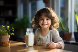 cute little Indian girl drinks milk in a glass, happy expressions