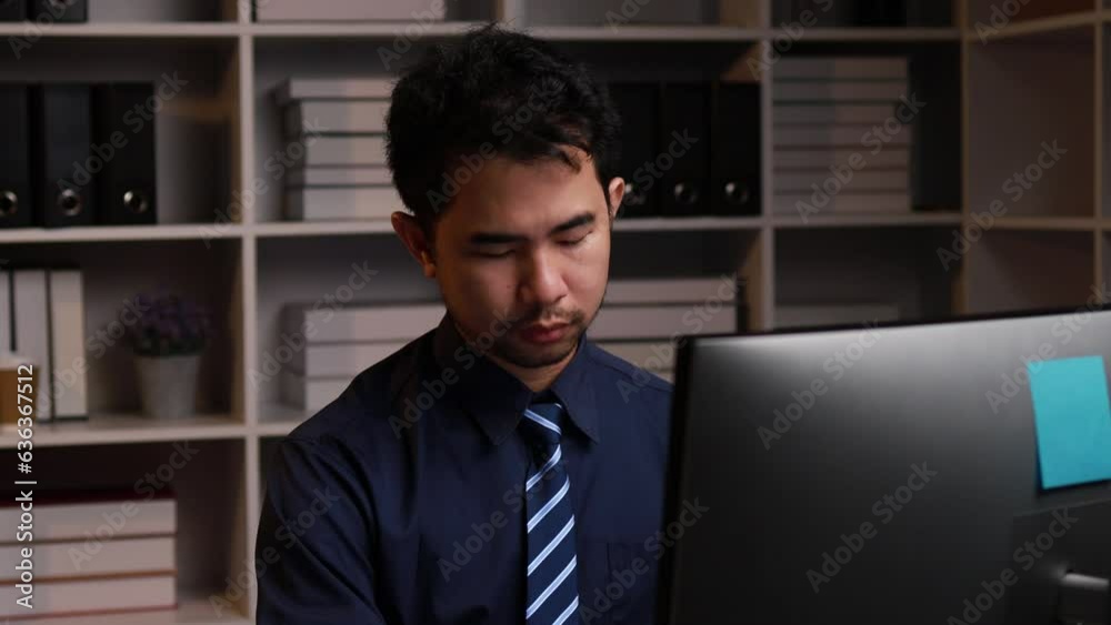 Businessman sitting working overtime, startup company employee working in the office with heaps of work papers on the desk, overtime work. Document management concept. Businessman sitting working overtime, startup company employee working in the office with heaps of work papers on the desk, overtime work. Document management concept.