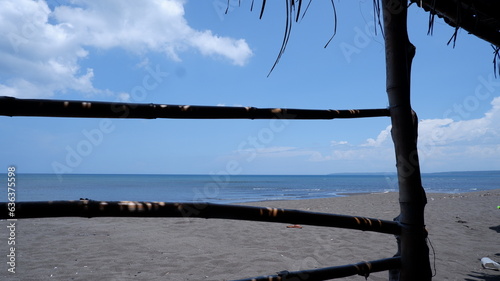 Bamboo cottage overlooking the sea in a bright sunlight. © Renato