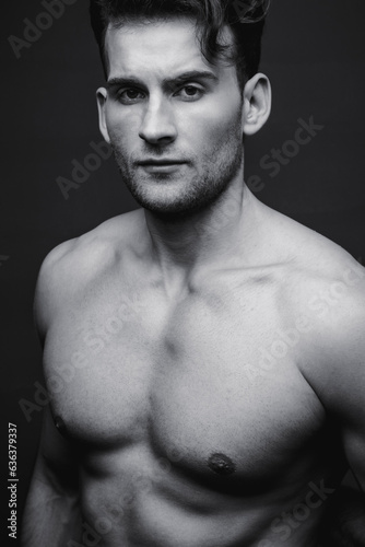Male beauty concept. Black and white portrait of handsome young man. Perfect hair and skin. Studio shot