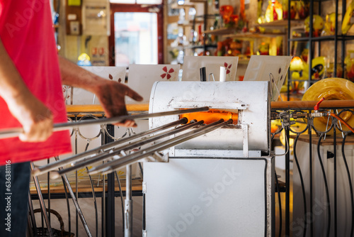 Glassblower crafting a Christmas bauble, from the heat of the oven to shaping it. Workshop based in France.
