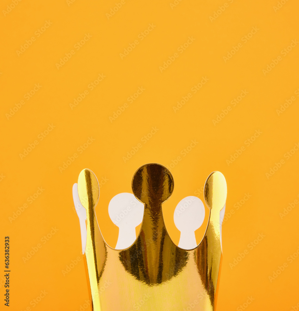 A gold, shiny, festive and decorative crown on a sunny yellow background. Colorful happy birthday decoration. Copy space for text. A gold, shiny, festive and decorative crown on a sunny yellow background. Colorful happy birthday decoration. Copy space for text.