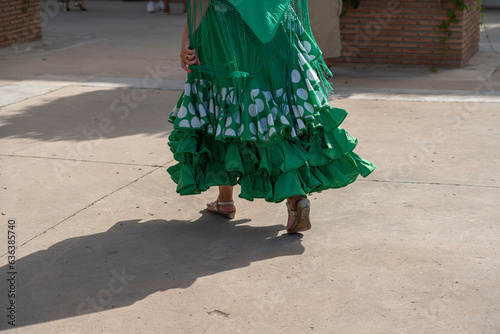  Flamenco's fiery passion and drama mirrored in a dress. The iconic polka dot pattern embraces the culture and essence of Spain's legendary dance form.