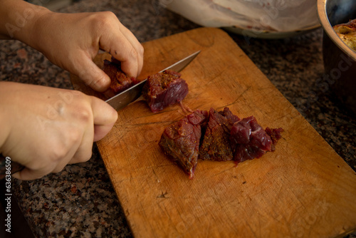  cutting the meat in a chopping board