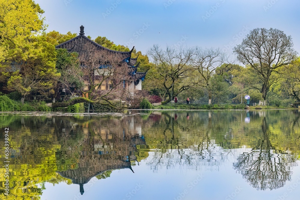 Scenic view of a temple near a tranquil lake in a park in Hangzhou, China