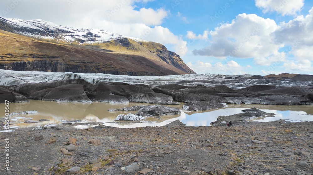 Breathtaking landscape featuring snow-capped mountains and a glacier with rocky outcroppings Breathtaking landscape featuring snow-capped mountains and a glacier with rocky outcroppings