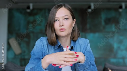 Close-up webcam view of talking female university student