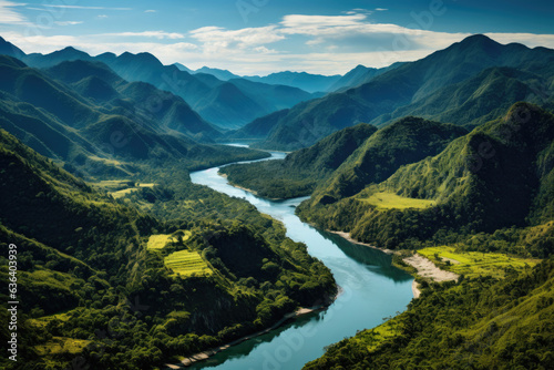 Aerial view of river in tropical green forest with mountains in background