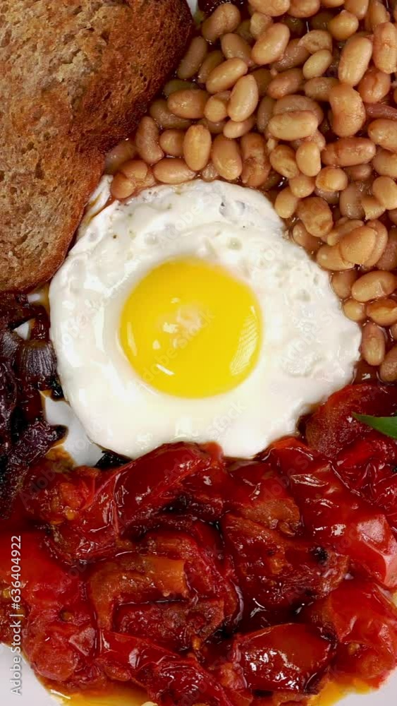 Traditional English breakfast for vegetarian with fried eggs, tomato, beans. Traditional English breakfast for vegetarian with fried eggs, tomato, beans.