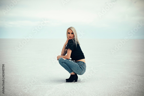 Beautiful blonde women posing in band AC/DC shirt at Utah Salt Flat photo