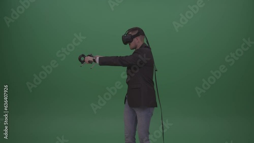 Smiling Dangerous Tough Man Shooting Enemies Around In Virtual Reality Game On Green Screen Chroma Key Wall Background (ID: 636407926)