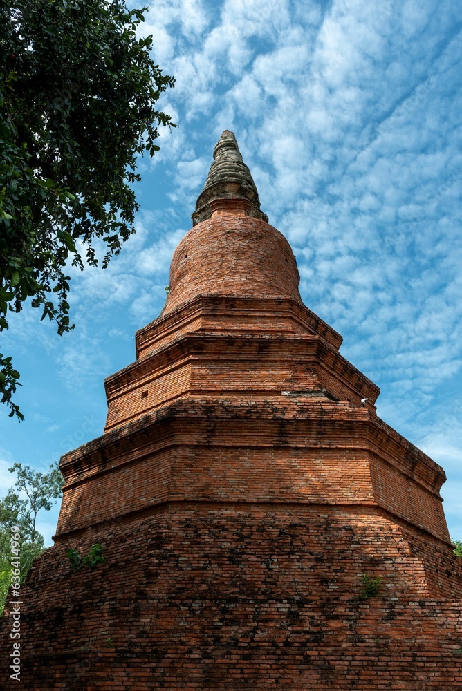 Vertical shot of an exposed brick pagoda under a blue sky in Ayuthaya, Thailand Vertical shot of an exposed brick pagoda under a blue sky in Ayuthaya, Thailand