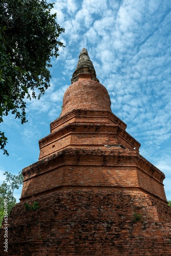 Vertical shot of an exposed brick pagoda under a blue sky in Ayuthaya  Thailand