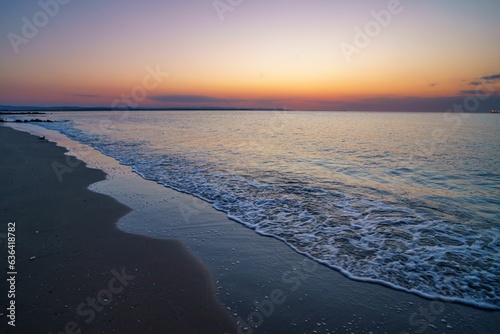 Seascape view at sunset with purple and clear sky background