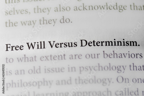 Close-up of the philosophical thought of Free Will Versus Determinism, on paper background