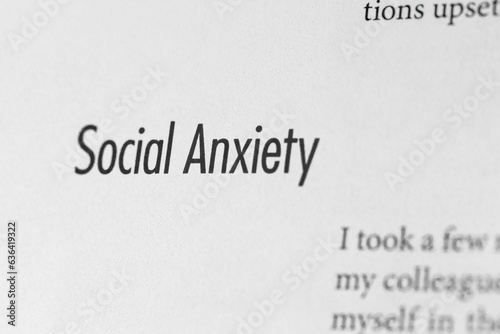 Close-up of the term social anxiety on paper background
