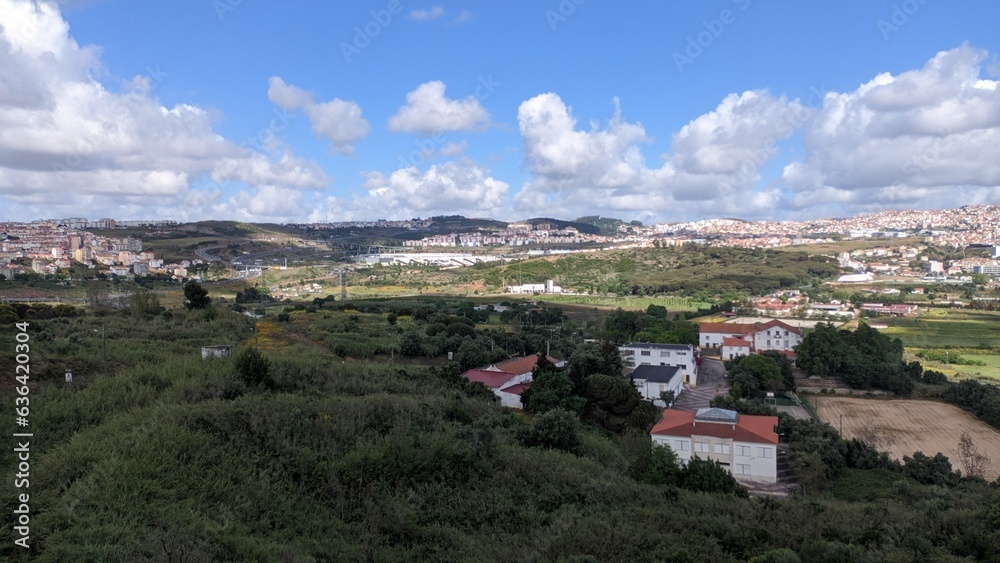 Portugal, suburbs of Lisbon, forest, house, field, city skyline, sky and clouds