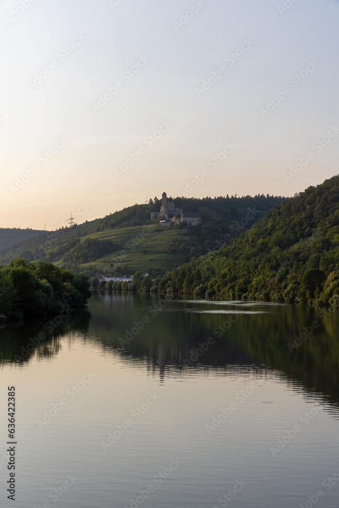 Hornberg Castle near Hassmersheim over the Neckar River in the evening with reflections Hornberg Castle near Hassmersheim over the Neckar River in the evening with reflections