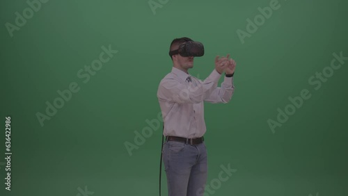 Young Businessman Working On Invisible Touch Pad with virtual reality on green screen (ID: 636422986)